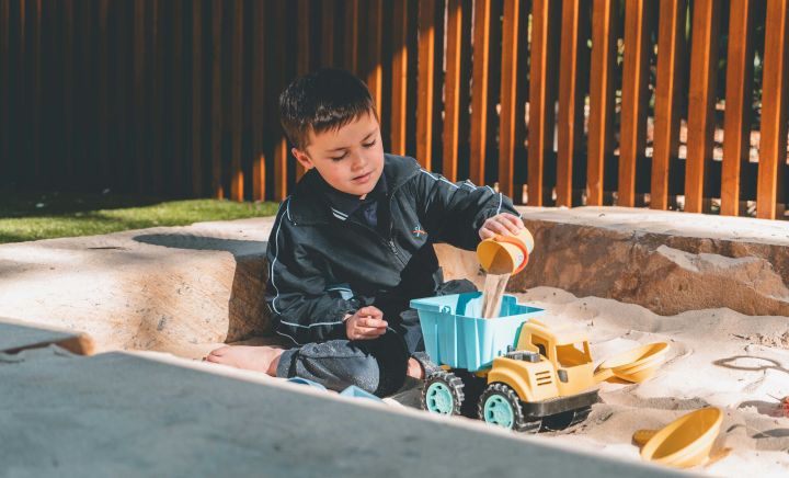 Student playing in sandpit